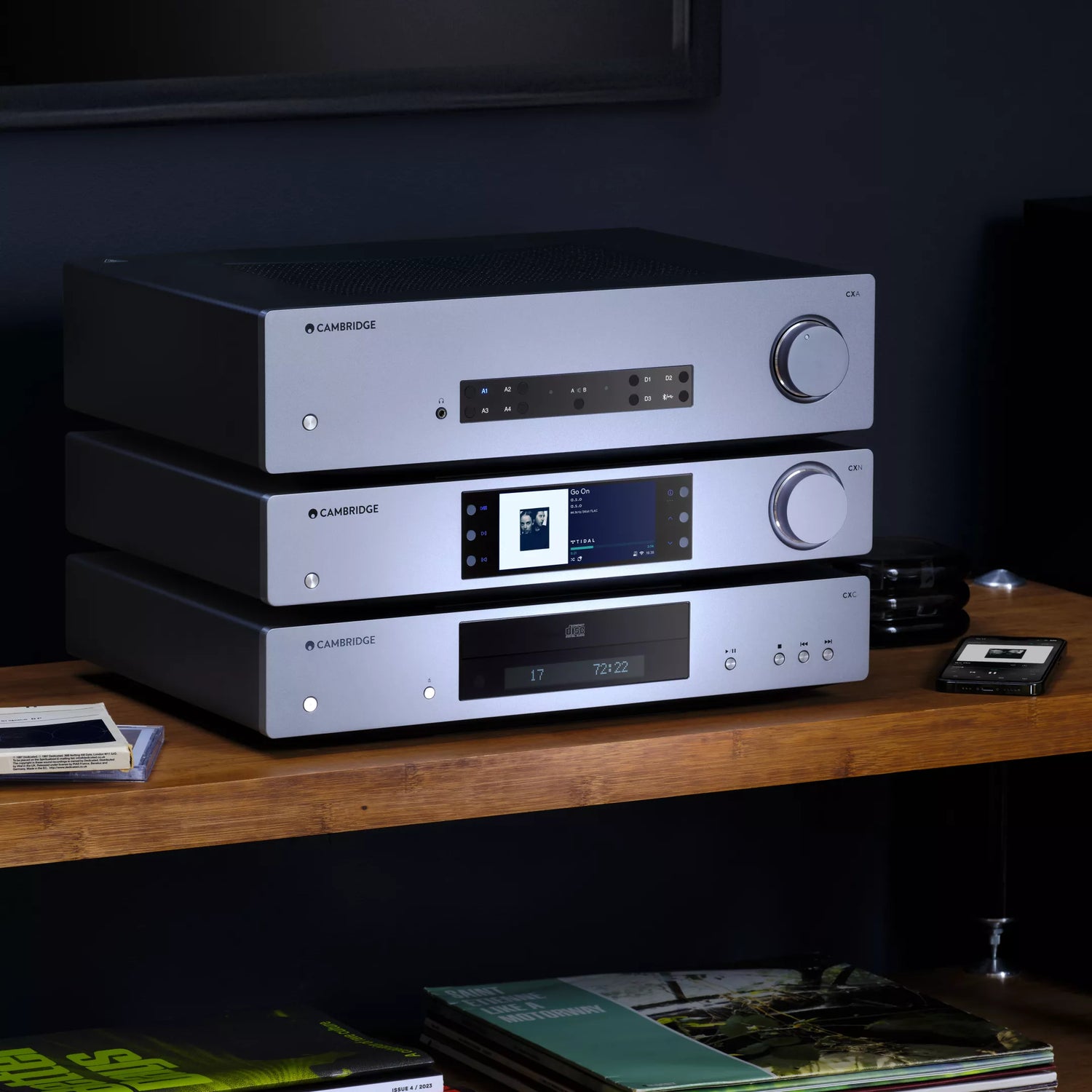 Stack of Cambridge audio equipment including Cambridge Audio CXC V2 CD Transport in a modern living room.