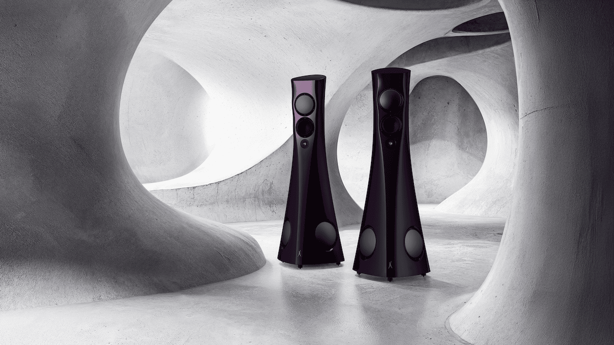 Two black Estelon Forza Reference Speakers in a futuristic, abstract architectural setting.