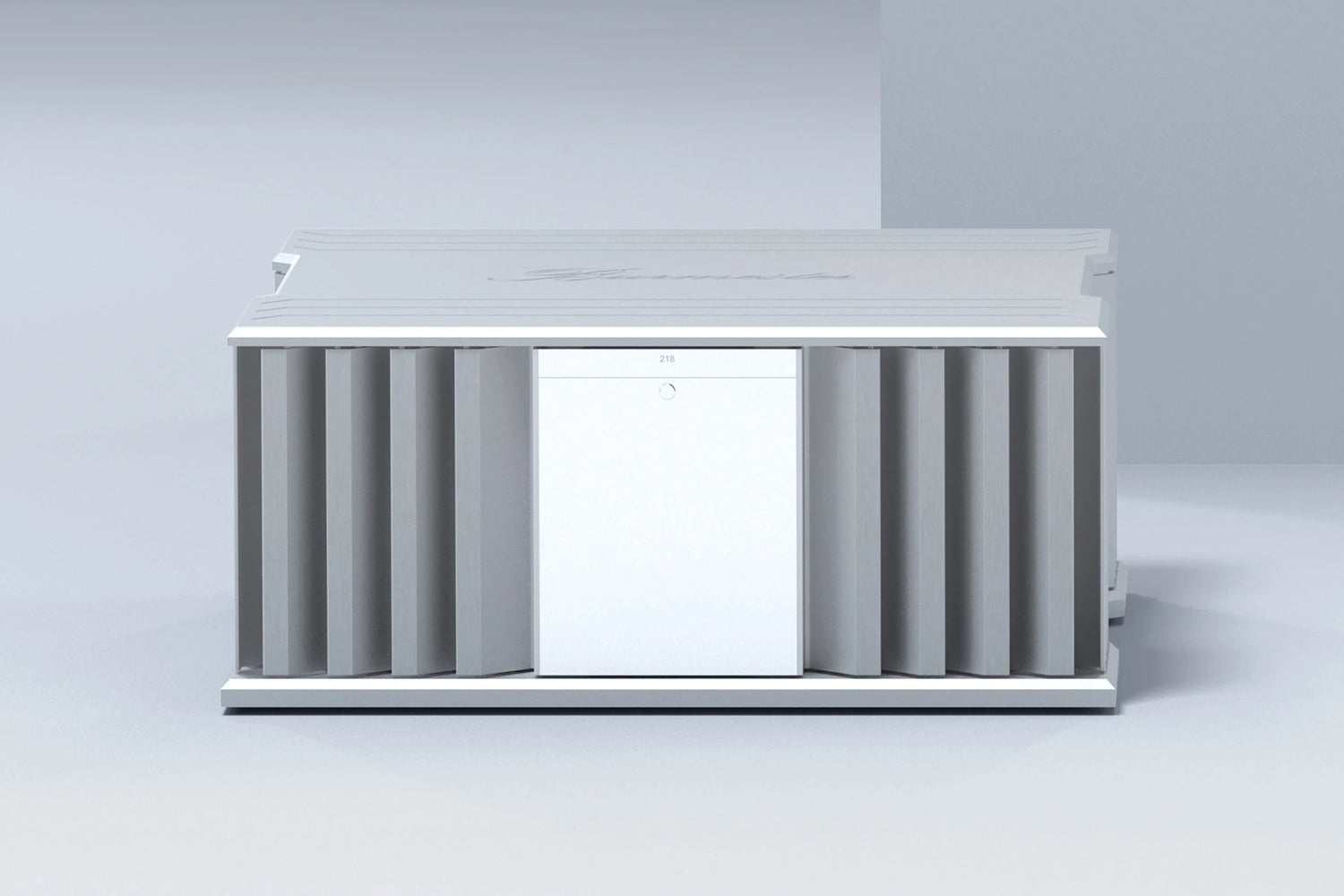 A front side of a silver Burmester 218 Reference Line power amplifier with cooling fins and ports on a gray surface - HiFi Centre.