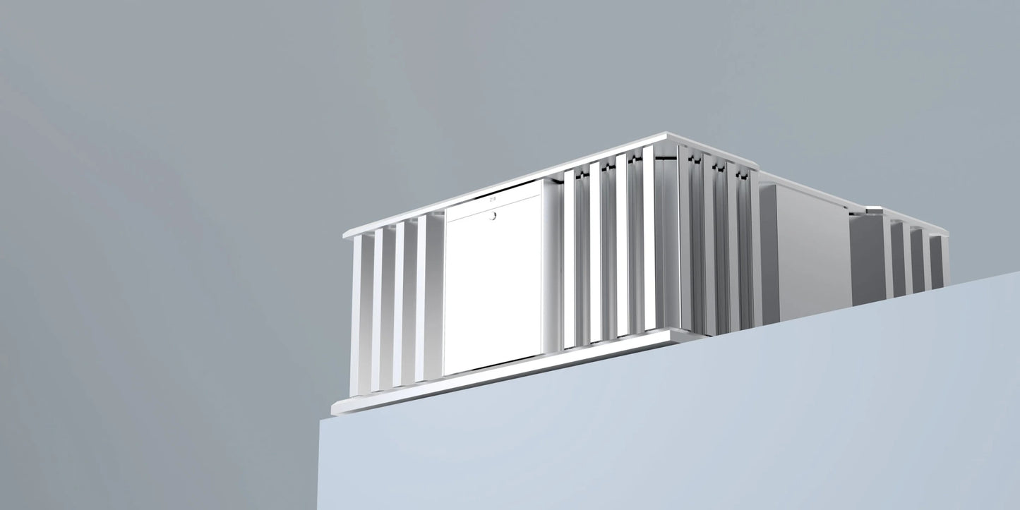 A side side of a silver Burmester 218 Reference Line power amplifier with cooling fins on a gray table - HiFi Centre.