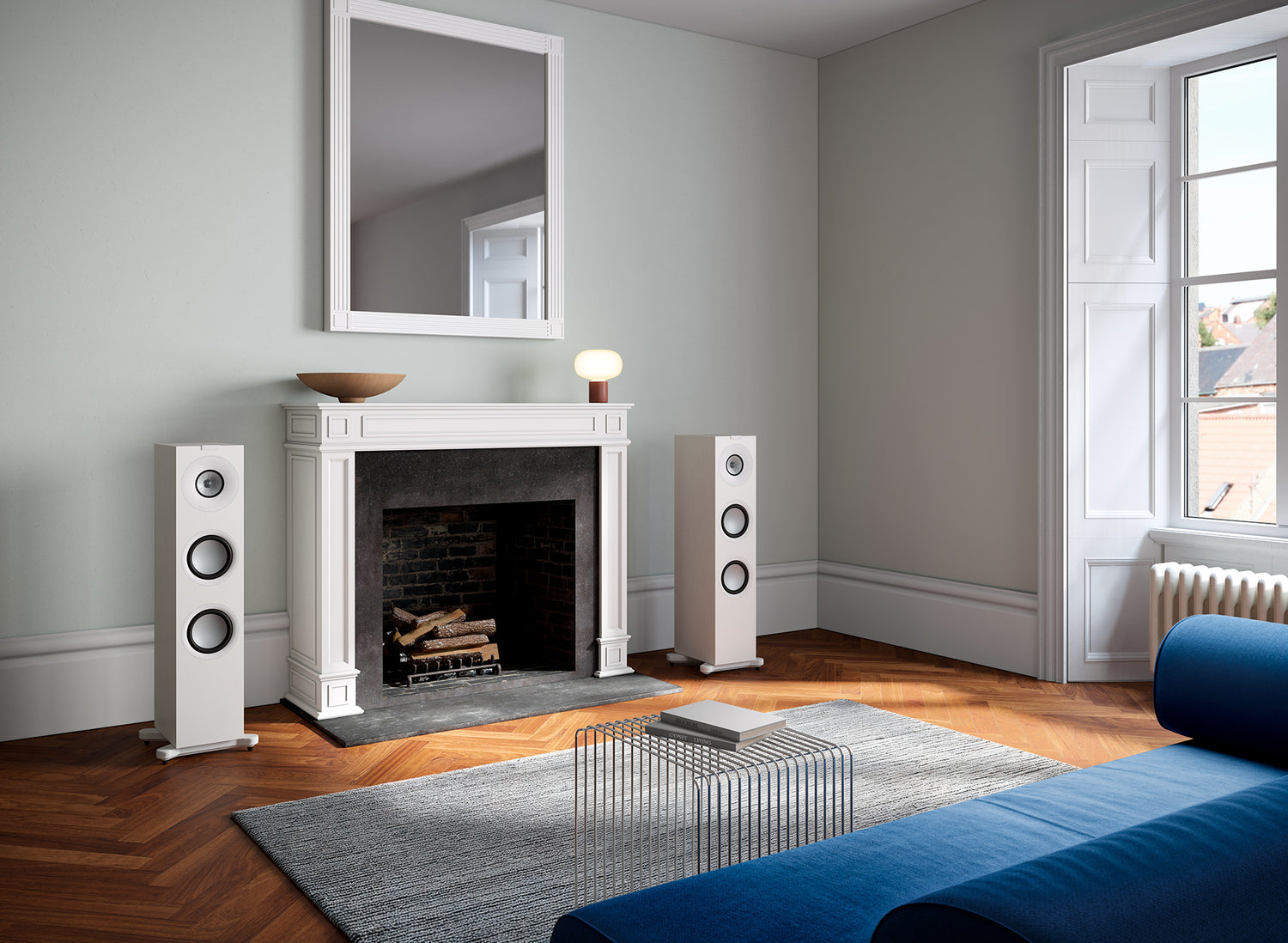 A pair of satin white KEF Q7 Meta Floor Standing Speakers in a modern family room.