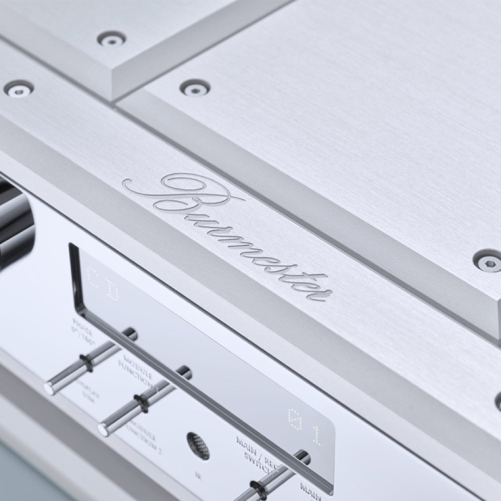 A detail view of a logo of a Silver Burmester 077 Reference Line Preamplifier with digital display and control knobs on the front panel, made of solid aluminum and carbon fiber damping - HiFi Centre.