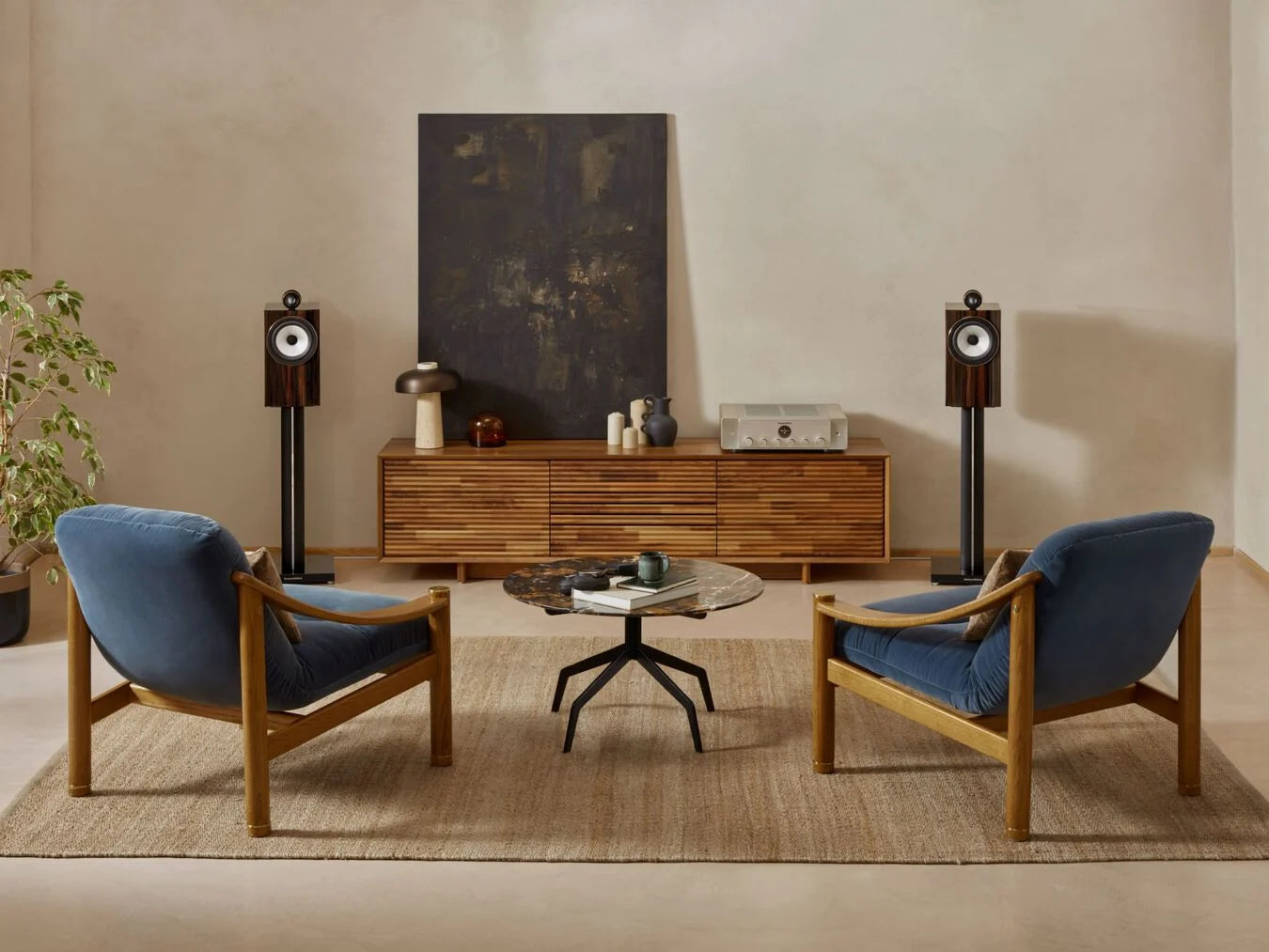 A pair of B&W 705 S3 Signature Bookshelf Speakers in a modern living room.