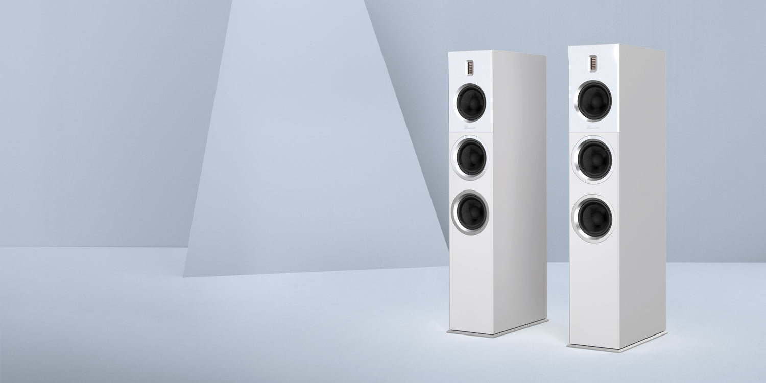 Two white Burmester B28 Classic Line Speaker on a light gray background