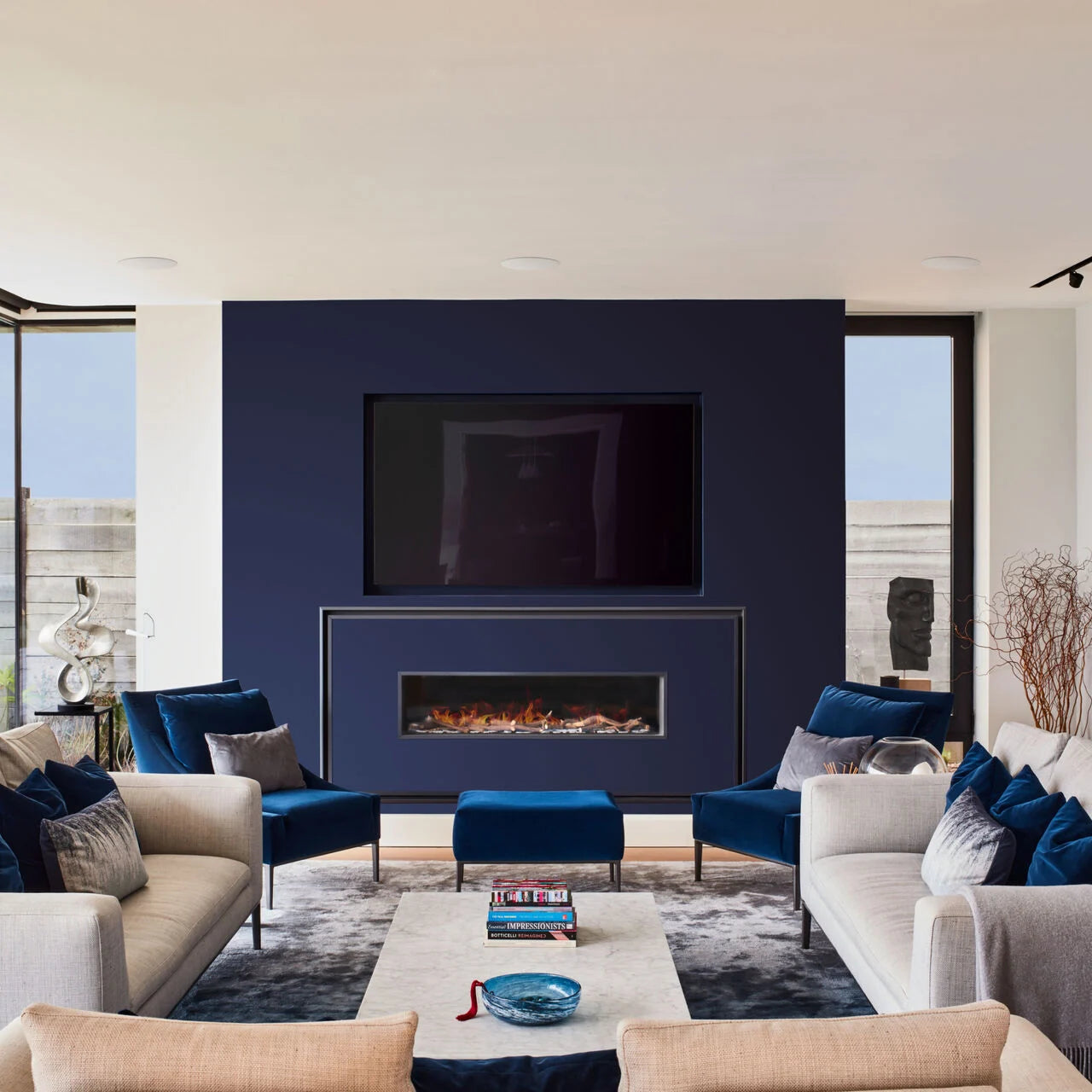 Three B&W CCM683 In-Ceiling Speakers installed on a ceiling in a modern living room.