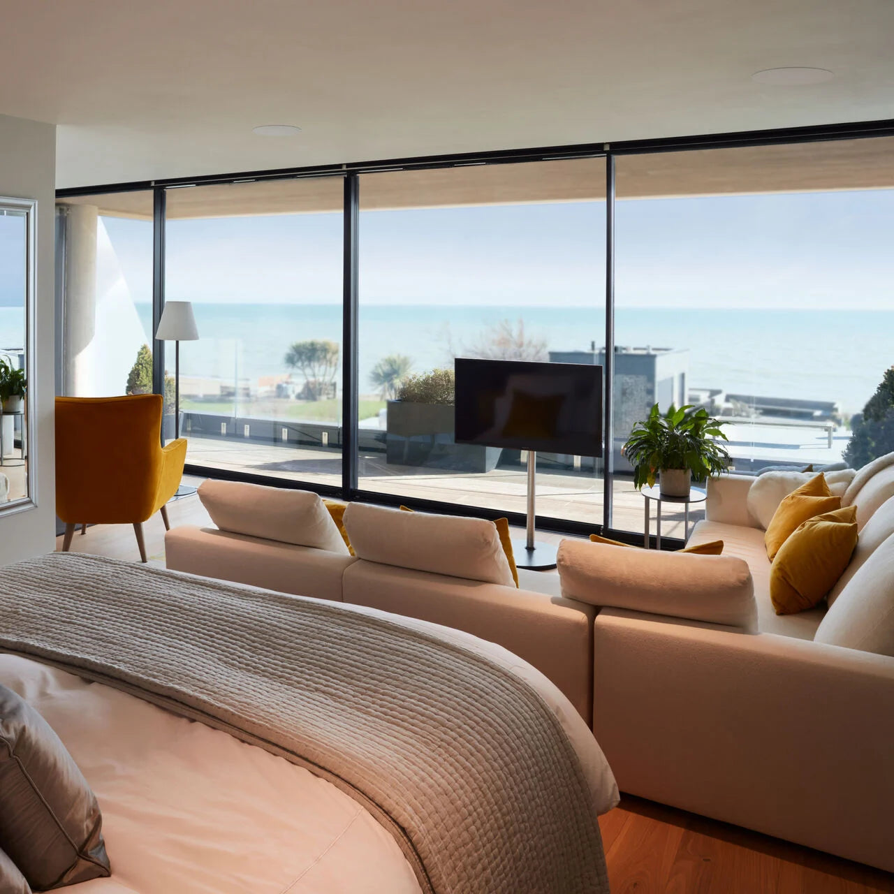 B&W CCM684 In-Ceiling Speakers in a modern seaside bedroom or a hotel room