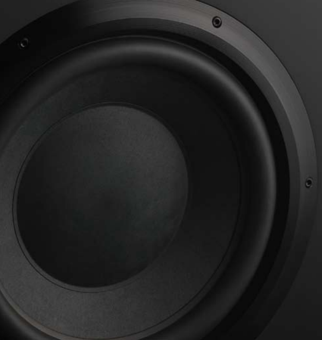 Close-up of a black B&W CTSW15 Custom Theatre Passive Subwoofer cone on a dark background.