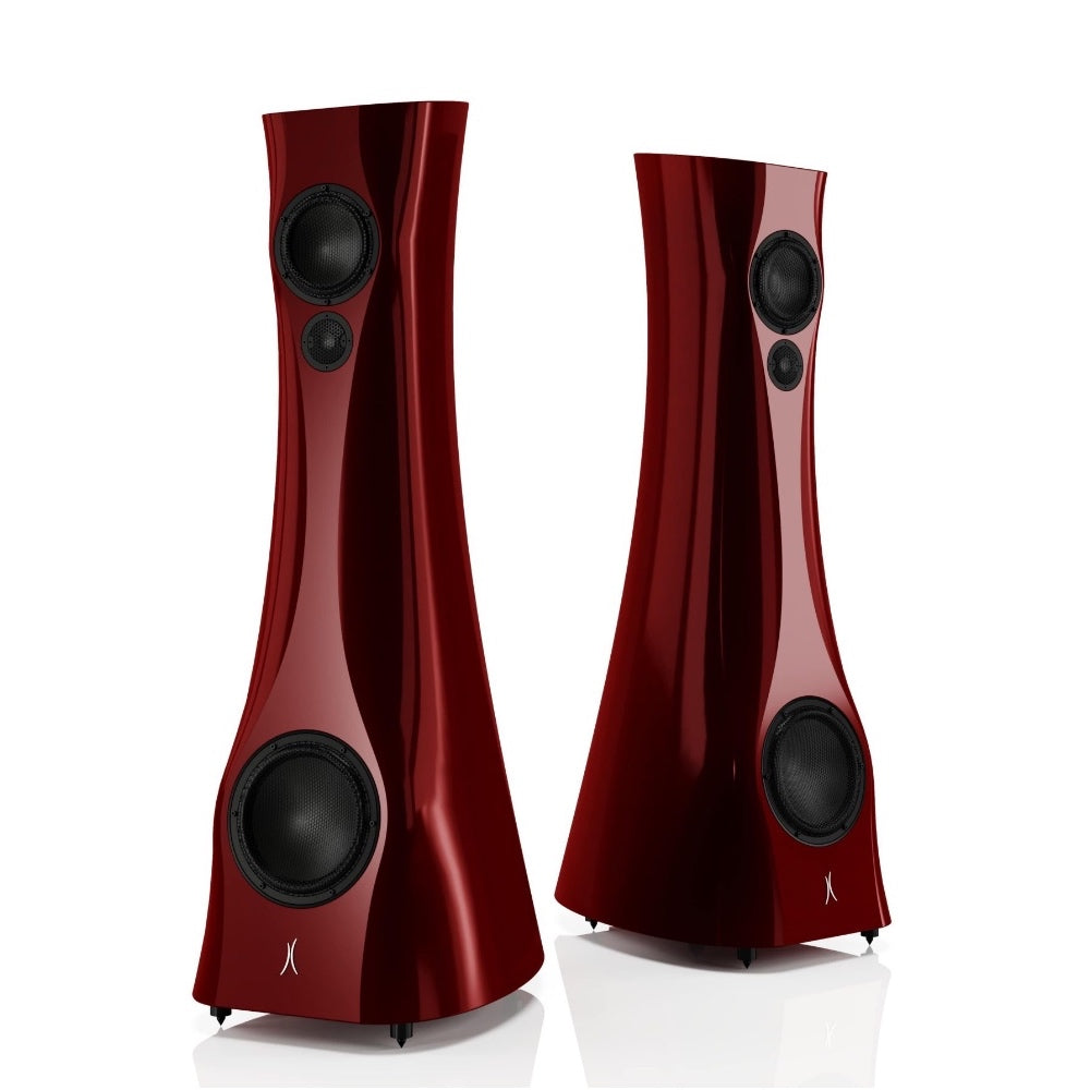 A pair of Red Rocket Liquid Gloss Estelon XB MK II reference speakers with a curved-sculptural design, standing in a reflective environment.