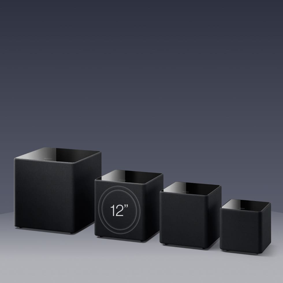 Set of black square KEF KUBE MIE Subwoofers with digital display on a gray background