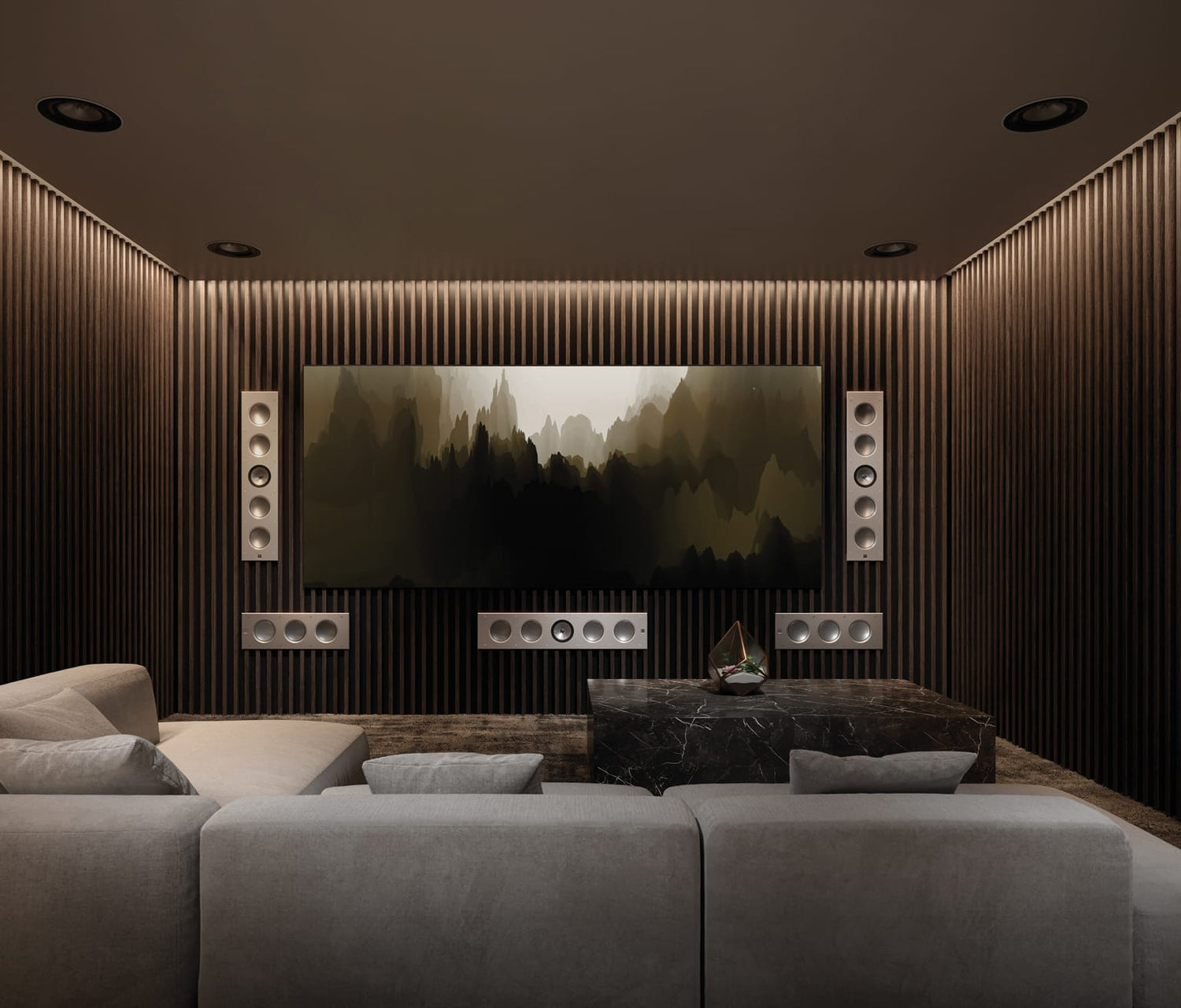 Modern home theater with a large screen displaying a nature scene, surrounded by comfortable seating and stylish decor with KEF Ci3160RLB-THX In-Wal Subwoofer installed.