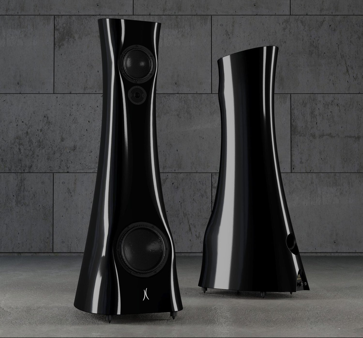 A pair of Black Lava Liquid Gloss Estelon XB MK II reference speakers with a curved-sculptural design, standing in an industrial environment.