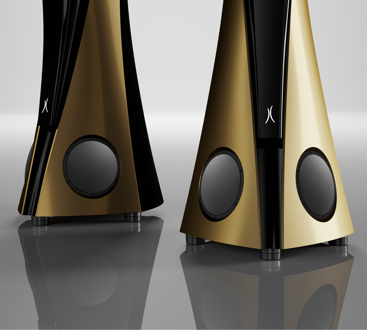 Pair of gold and black speakers on a reflective surface with a light gray background - Estelon Extreme MK II Ultimate Speaker.