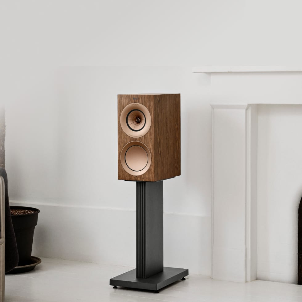 Walnut KEF speaker on a KEF S3 Floor Stand for R3 against a white wall