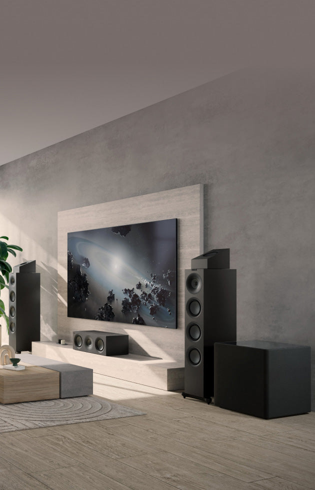 Modern living room with a large TV and surround sound KEF Q11 Meta Floor Standing Speaker.