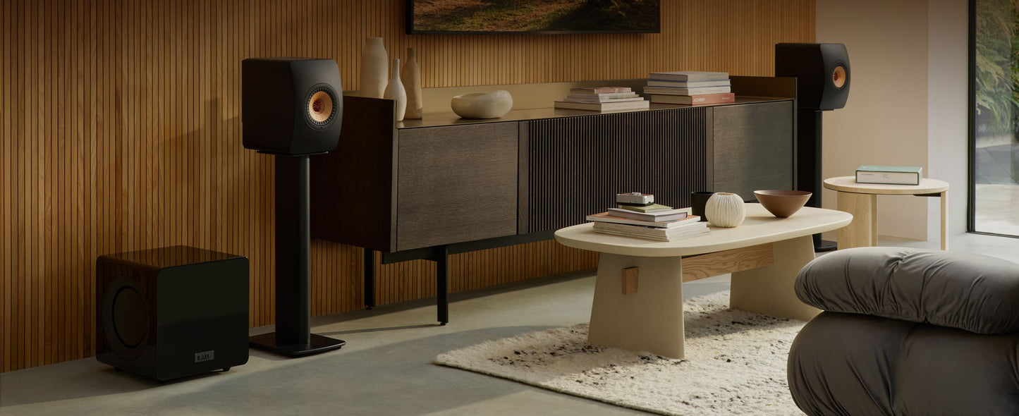 Modern living room with stylish furniture, a black KEF KC92 Dual 9” Subwoofer, and decor.