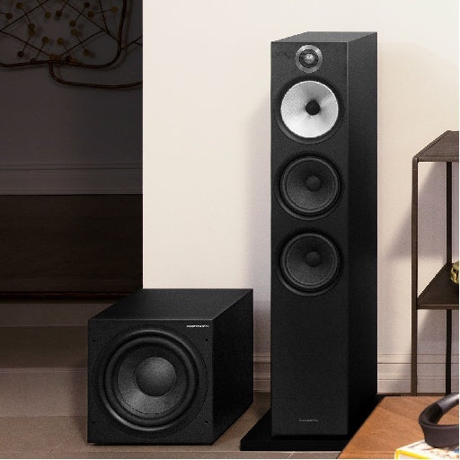 A black B&W ASW610XP 10” Subwoofer, and a tall B&W standing speaker.