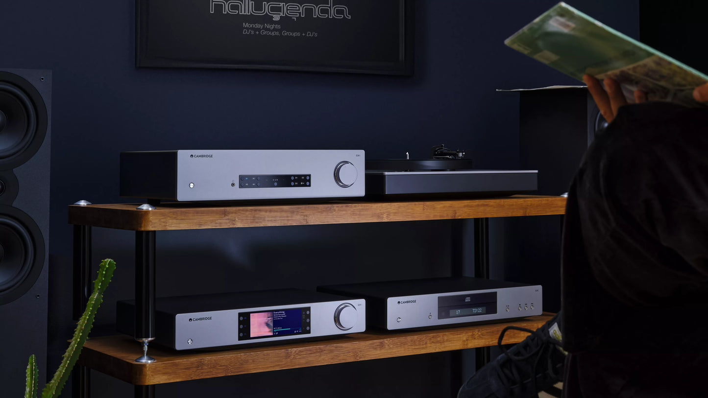 Cambridge Audio CXA81 MKII Integrated Amplifier on a wooden shelf with a dark wall background