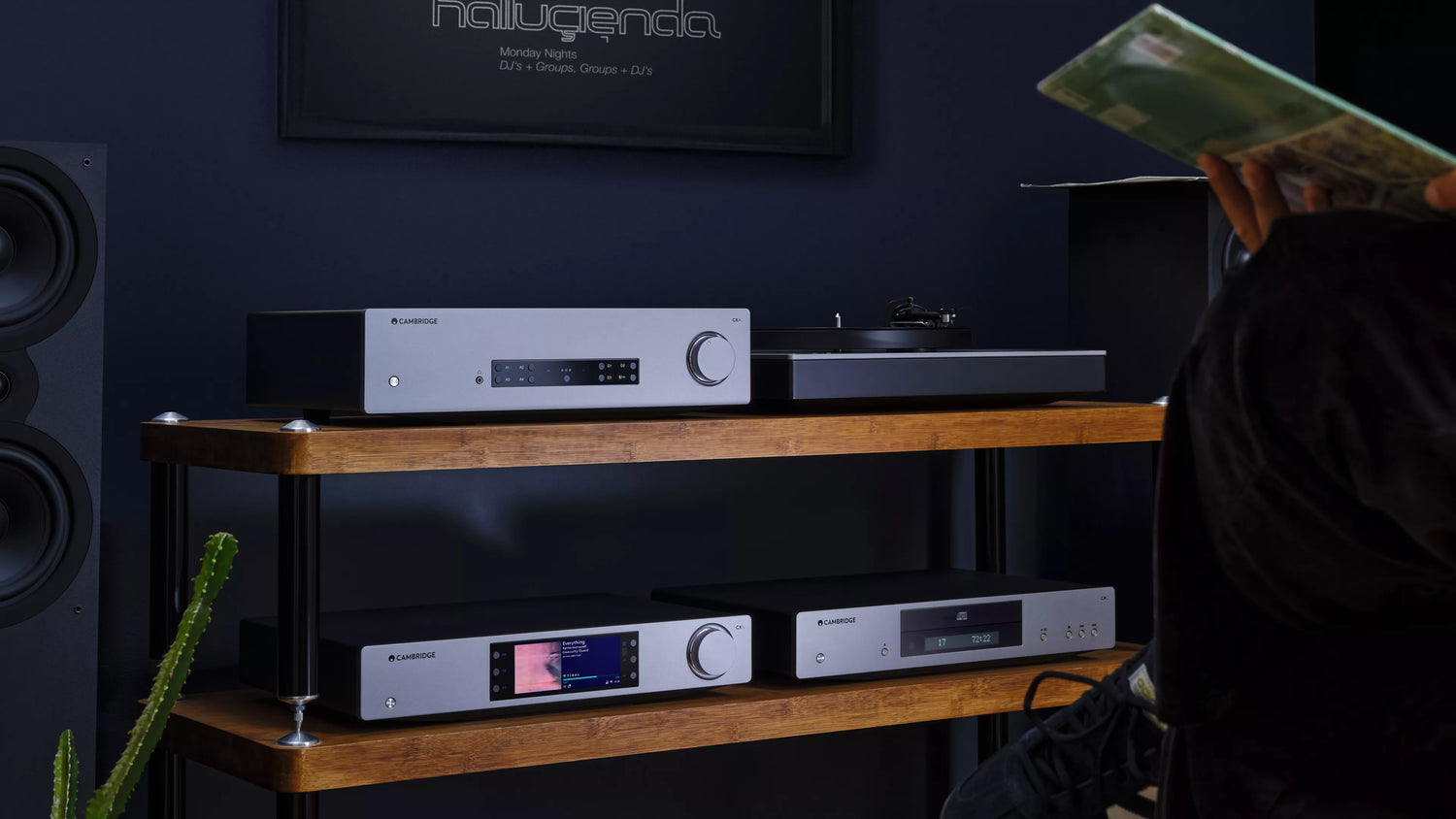 Cambridge Audio CXA81 MKII Integrated Amplifier on a wooden shelf with a dark wall background