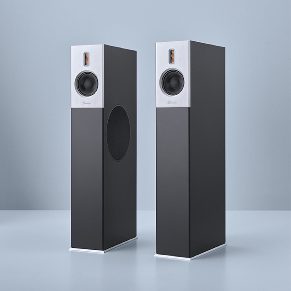 A pair of Burmester B38 top line speakers, featuring a slim, elegant design with a black finish and a front-panel speaker on each unit - HiFi Centre.