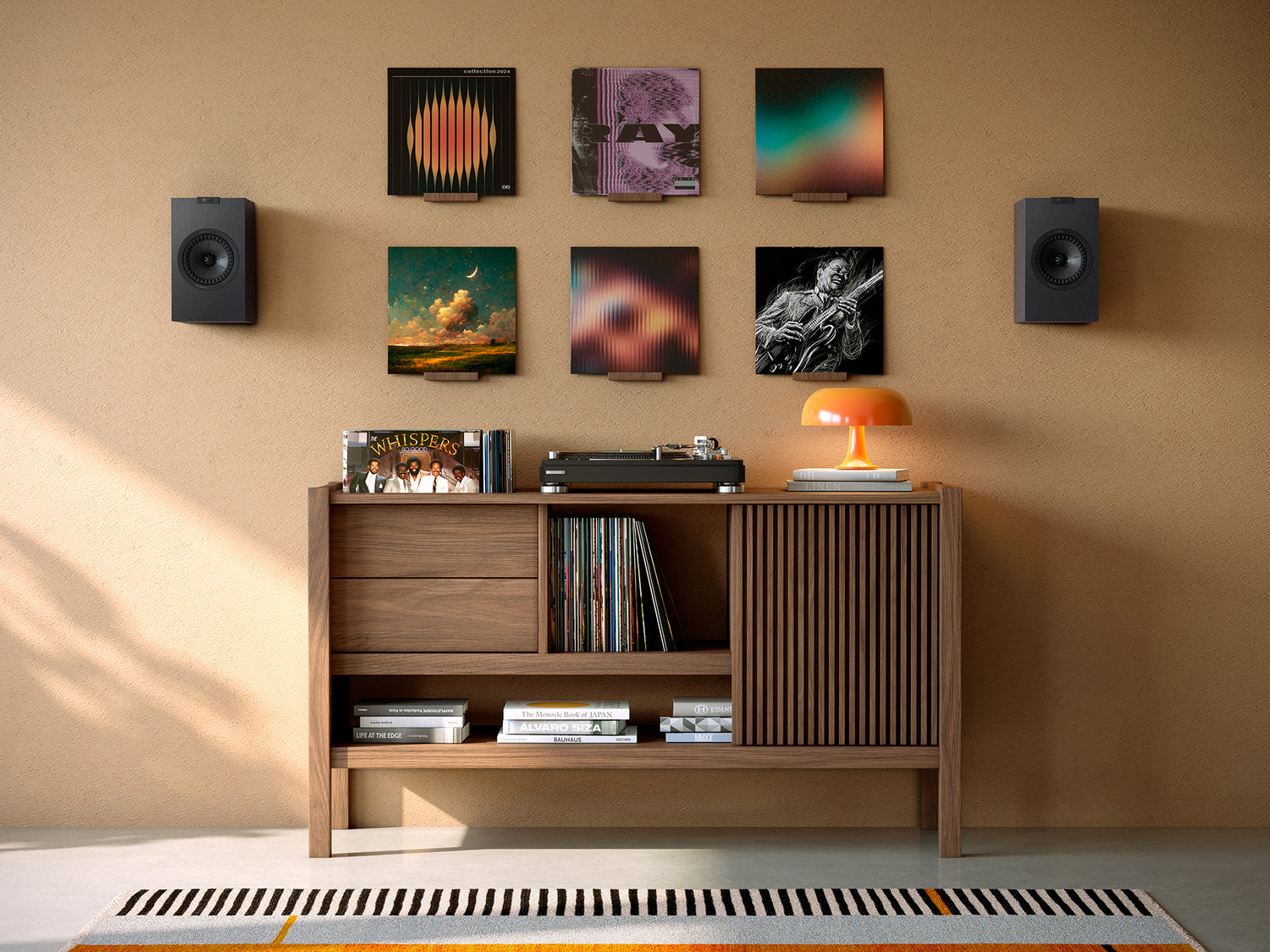 A pair of black KEF Q1 Meta Bookshelf Speakers with a modern design installed on a wall in a modern living room.