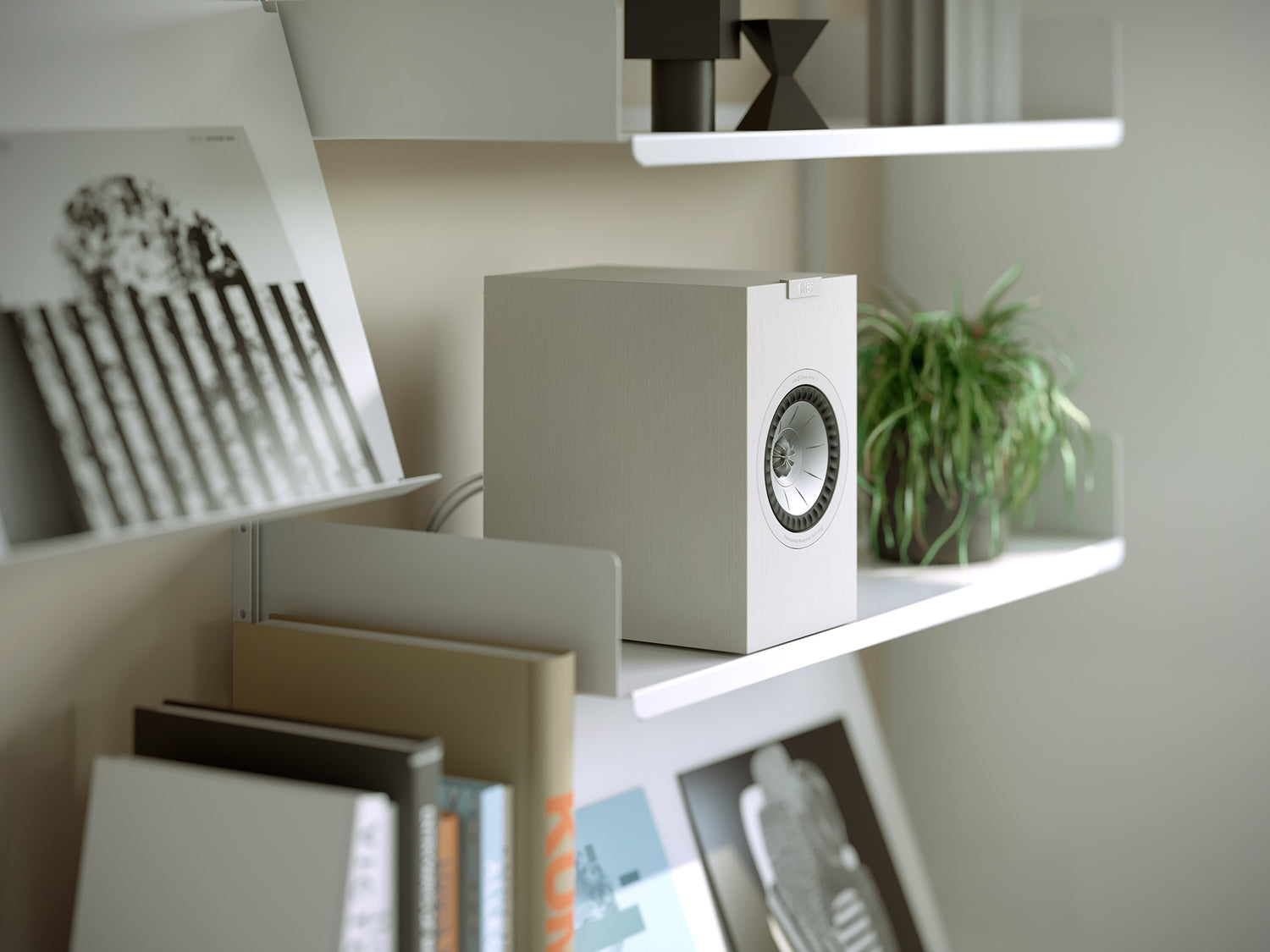 A closeup on a of white KEF Q1 Meta Bookshelf Speakers with a modern design.