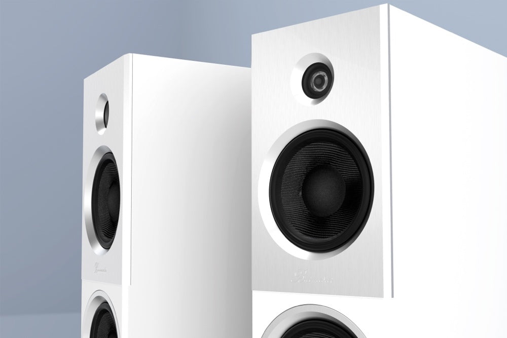 A closeup view of a white Burmester B18 Floor Standing Speaker - HiFi Centre. 