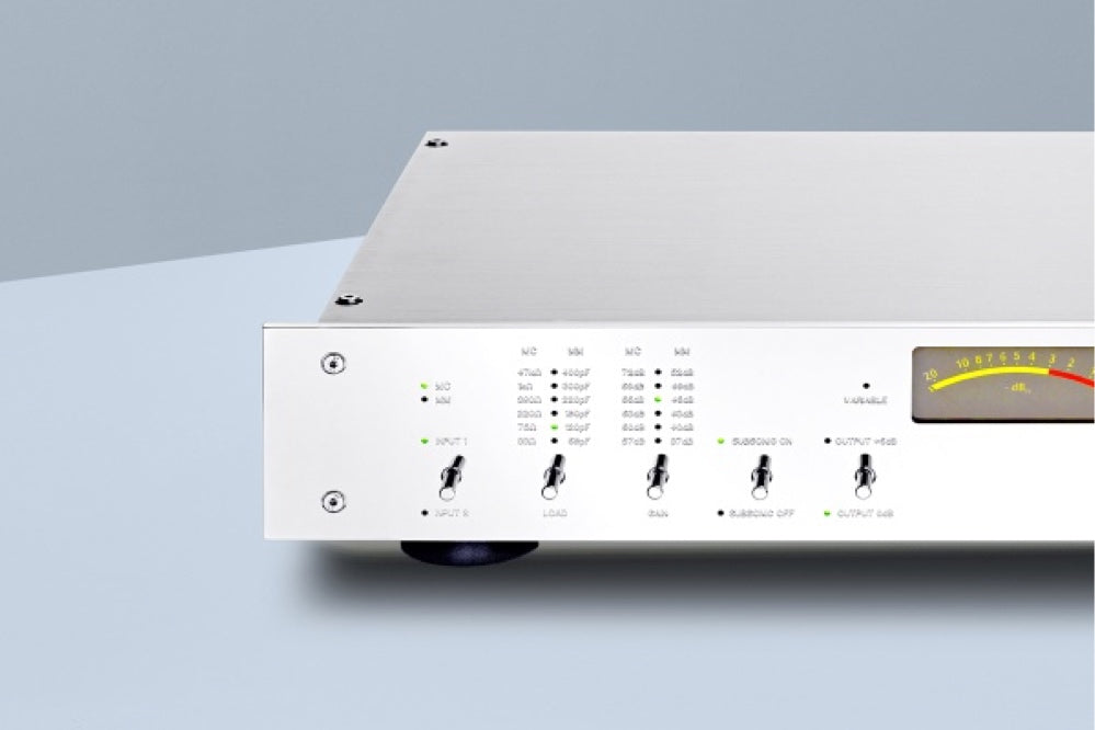 A detailed view of a silver Burmester 100 Top Line Phono Preamplifier with a classic chrome front panel, visible toggle switches, and a VU meter - HiFi Centre.