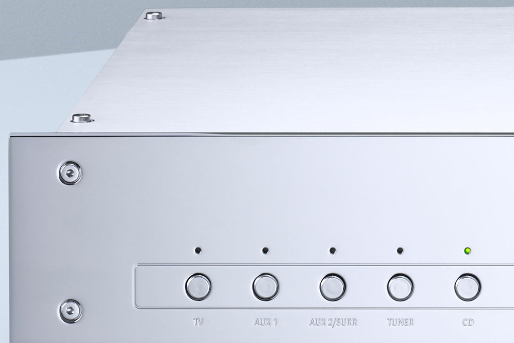 A detail on buttons of a silver Burmester 101 Classic Line Integrated Amplifier with a front-facing volume knob and input selection buttons - HiFi Centre.