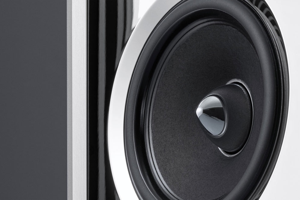 A closeup detail view of a Burmester BC150 floor-standing reference line speaker, featuring a white and gray color scheme with a solid aluminum frame - HiFi Centre.