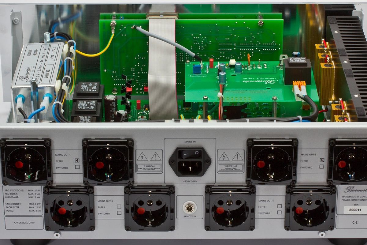 Close-up of a silver Burmester 948 Power Line Conditioner with green circuit board and various connectors - HiFi Centre.
