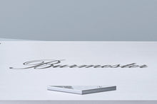 A closeup of a logo of a silver Burmester 956 MK2 Classic Line Power Amplifier - HiFi Centre.