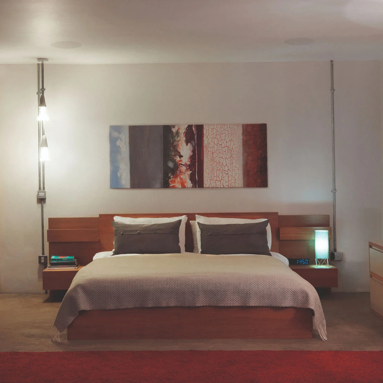 A modern bedroom with a pair of B&W CCM382 In-Ceiling Speakers installed in the ceiling.
