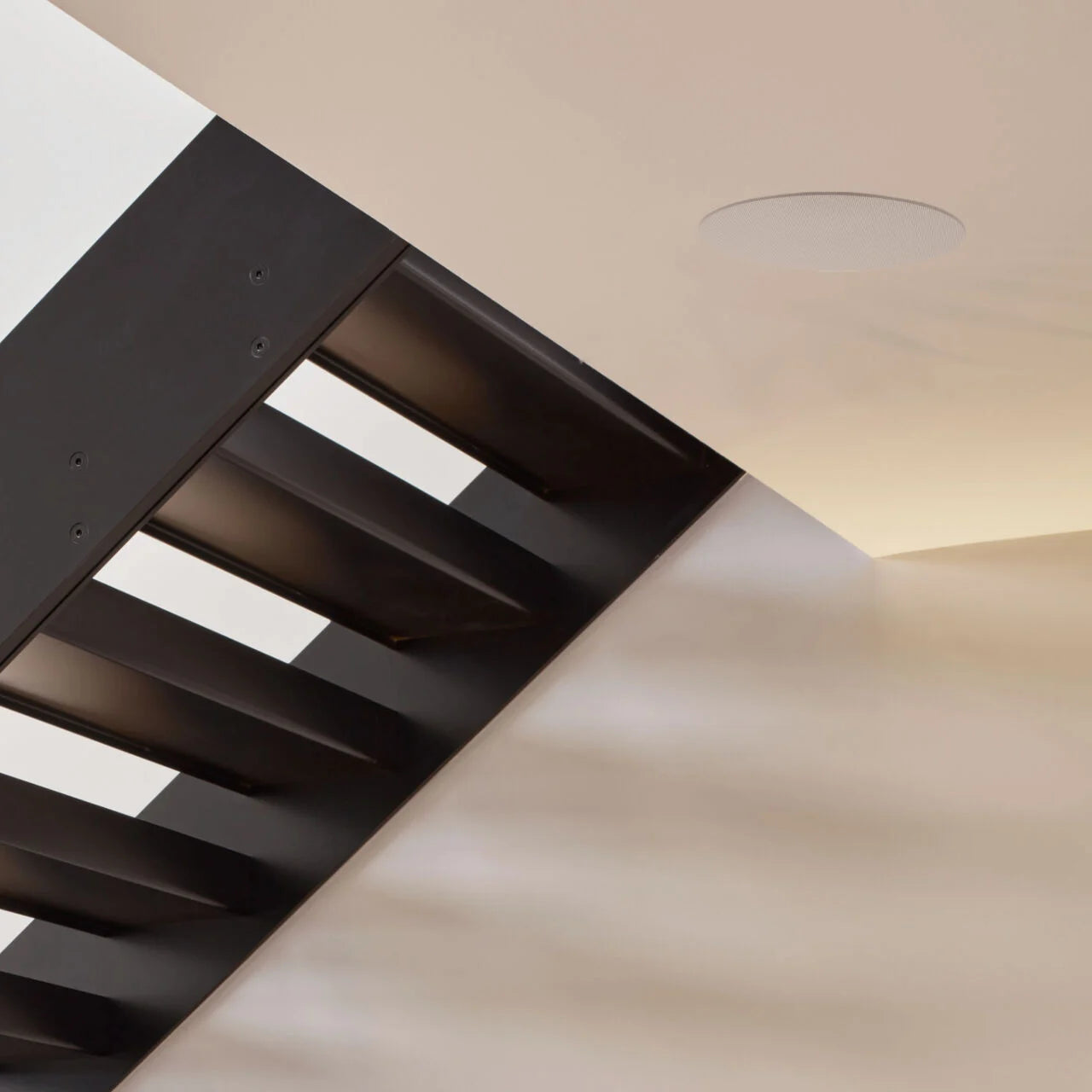 B&W CCM663 In-Ceiling Speaker installed in a hallway under the stairs