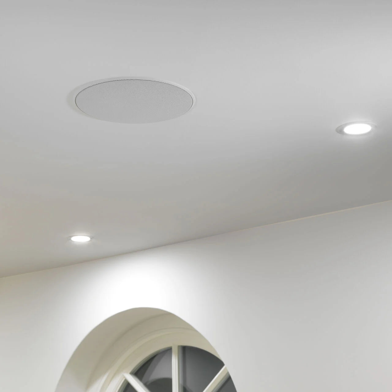 A B&W CCM663SR In-Ceiling Speaker installed on a ceiling in a modern home.