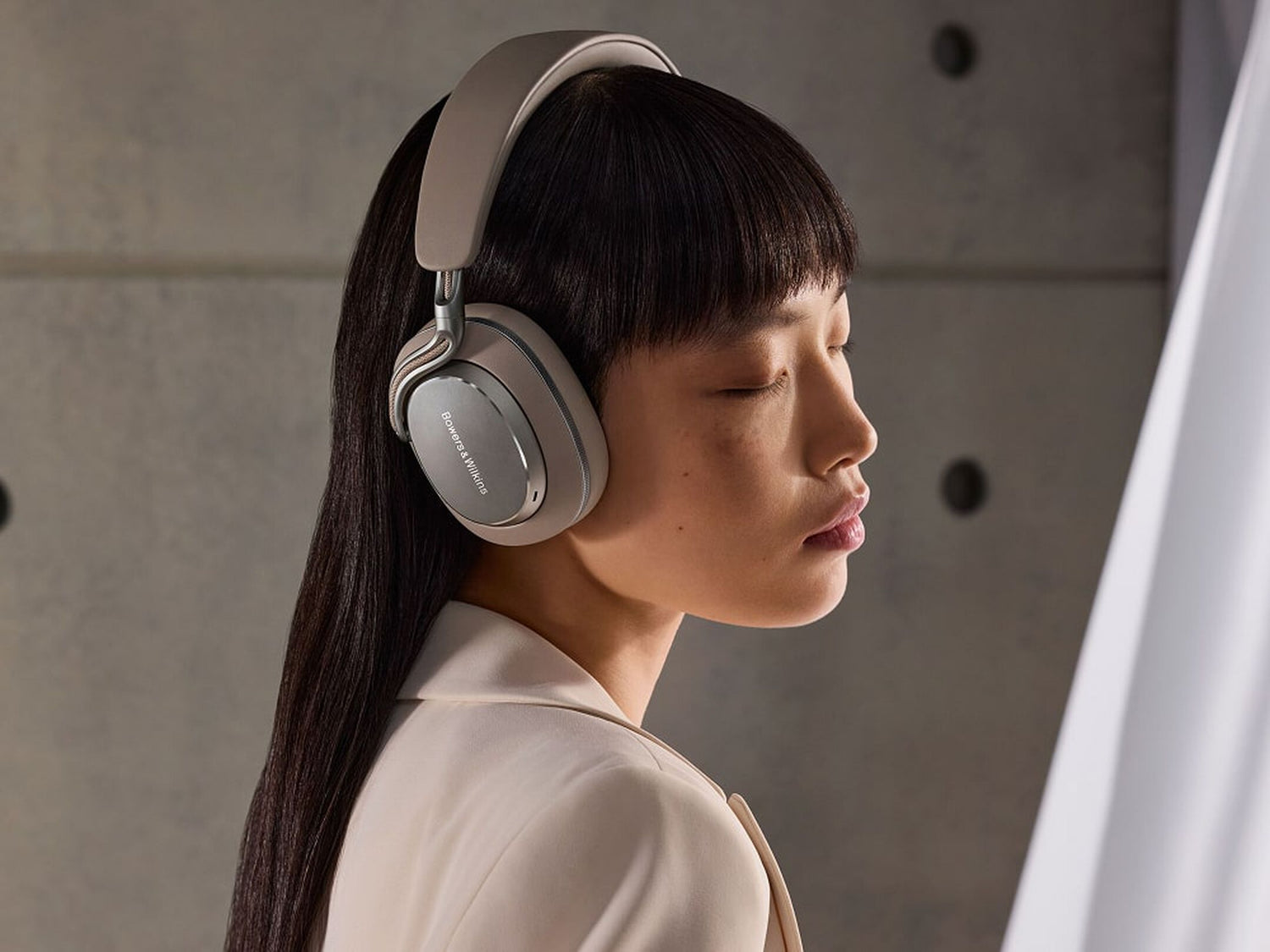Person wearing Bowers & Wilkins PX8 S2 Wireless Headphones in a neutral setting