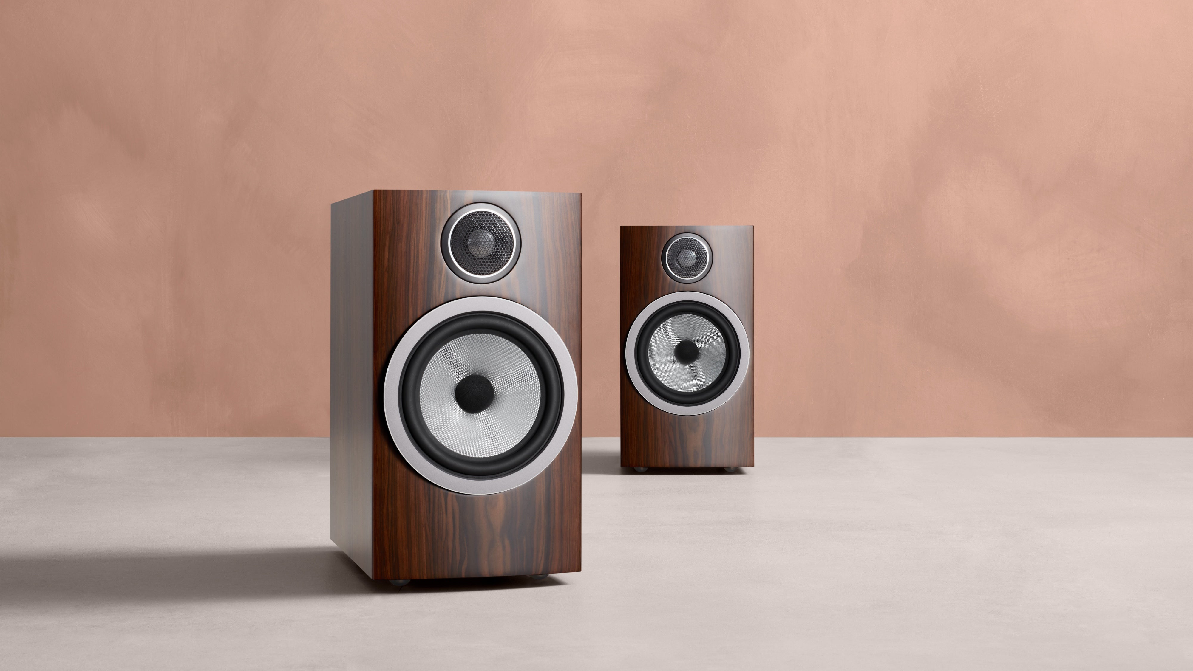 A closeup of two B&W 706 S3 Bookshelf Speakers in mocha finish.