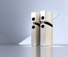 Pair of white Burmester BX100 Reference Speaker on a reflective surface with a gradient background