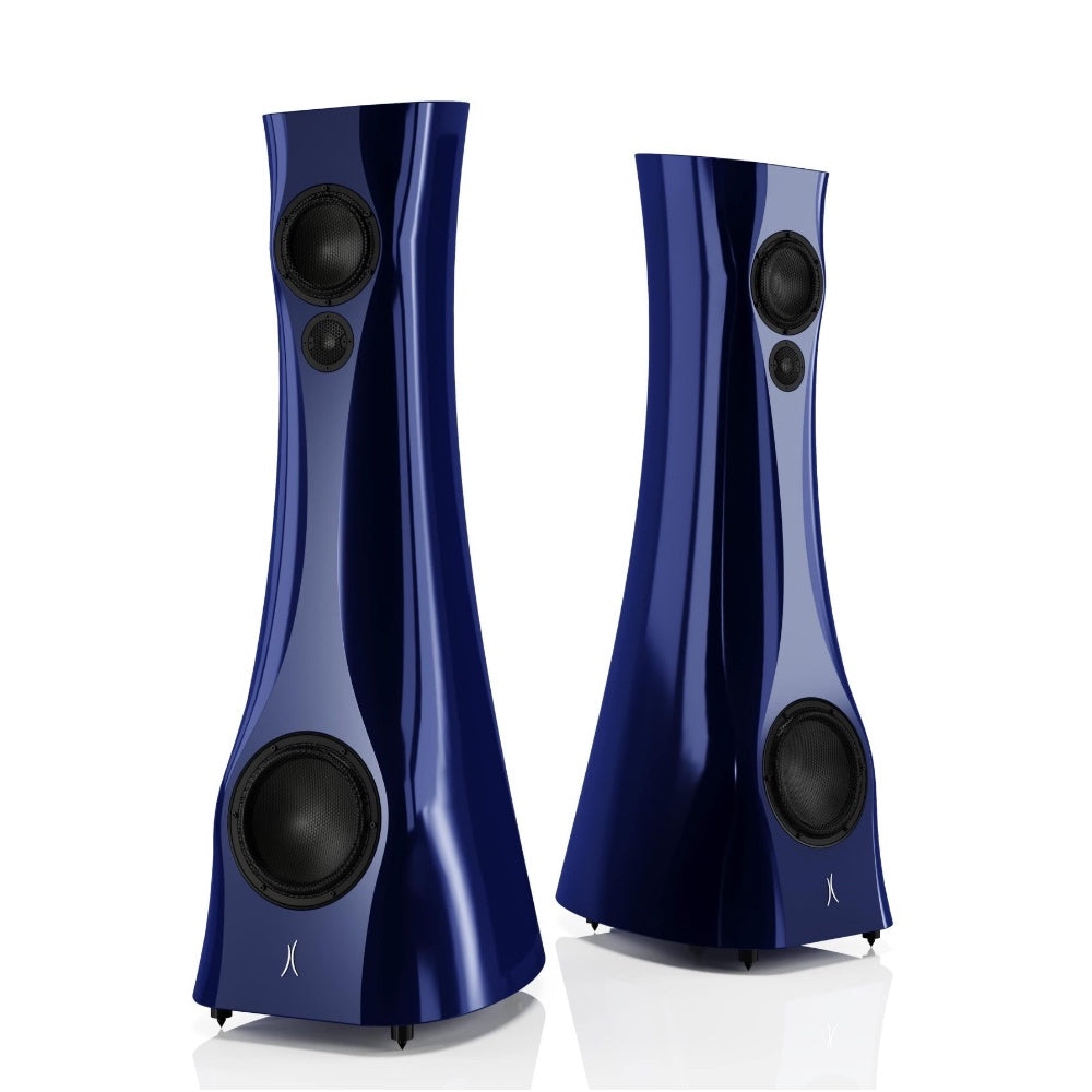 A pair of Blue Cobalt Liquid Gloss Estelon XB MK II reference speakers with a curved-sculptural design, standing in a reflective environment.