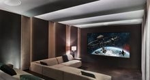 Modern home theater with a large screen displaying an outer space scene, with KEF Ci250RRM-THX Extreme In-Ceiling
speakers installed, surrounded by comfortable seating.