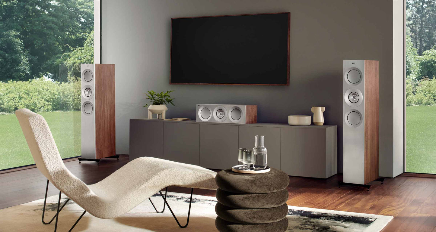 Modern living room with a television, KEF Reference 2 Meta speaker, and decorative items.