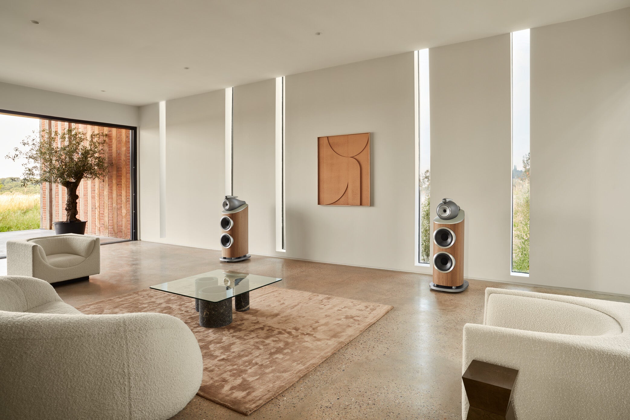 A pair of B&W 801 D4 Reference Speakers in walnut finish in a modern living room.