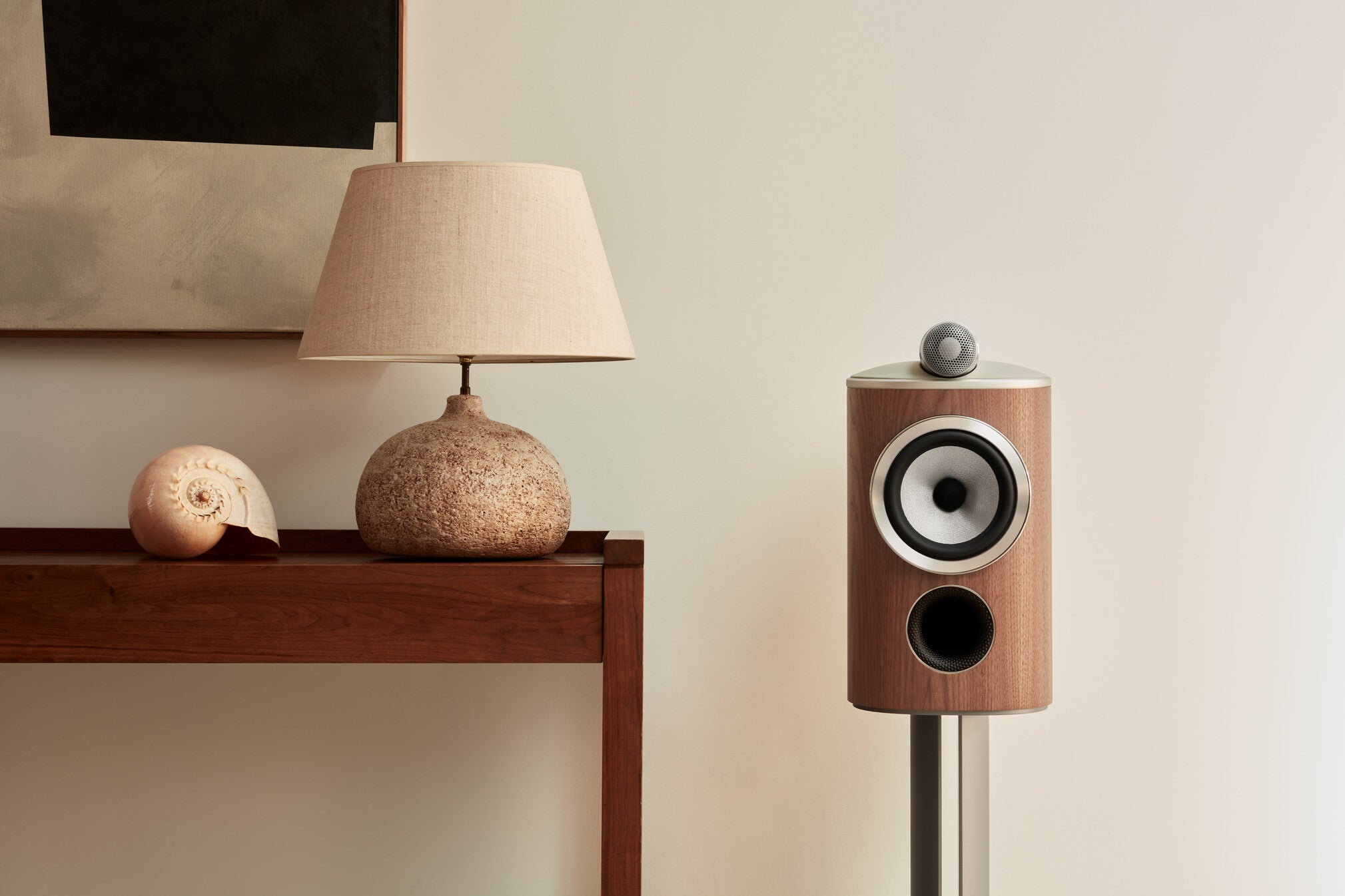 A closeup on a B&W 805 D4 Reference Speaker in walnut finish in a modern living room.
