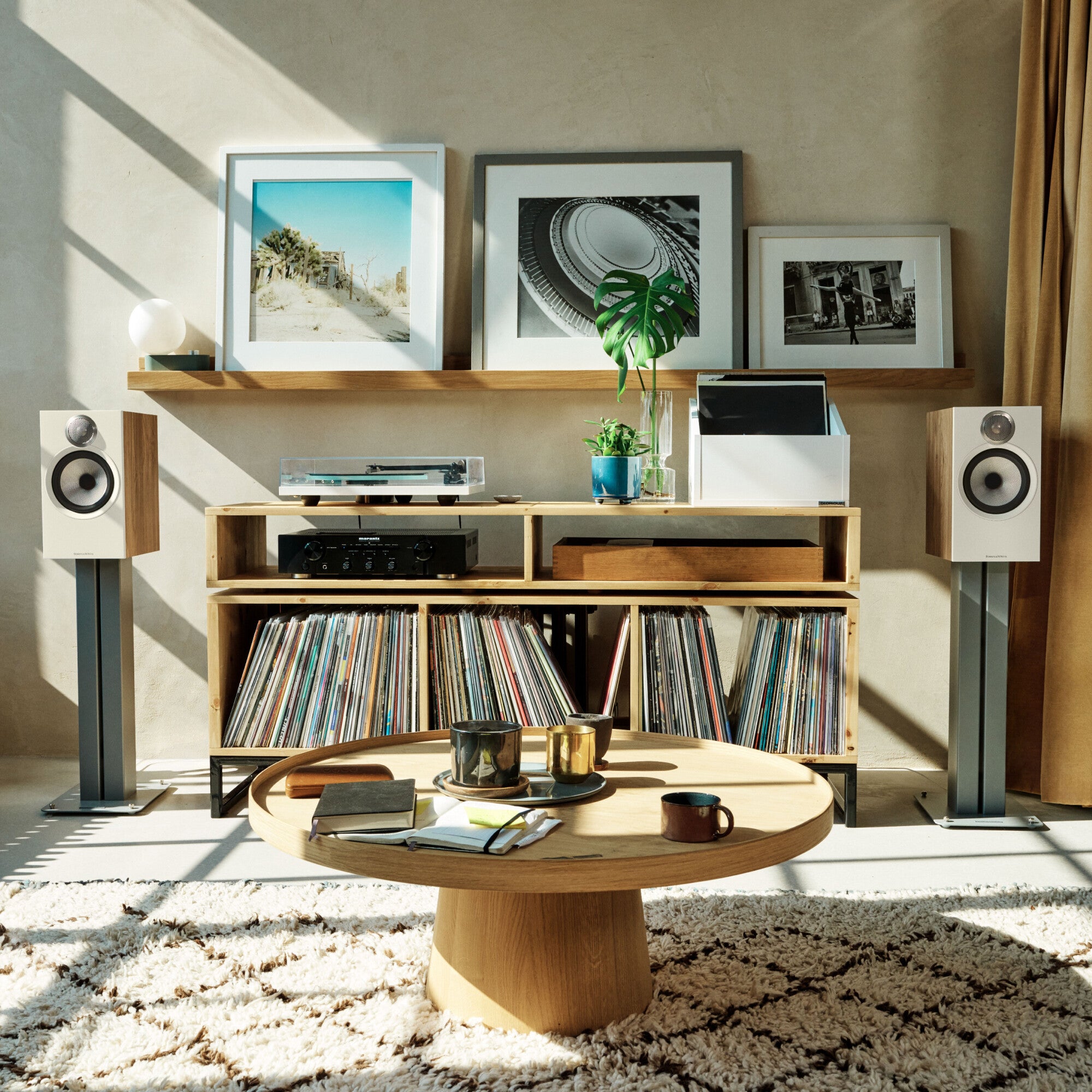 A set of B&W 606 S3 Bookshelf Speakers standing in a modern styled living room.