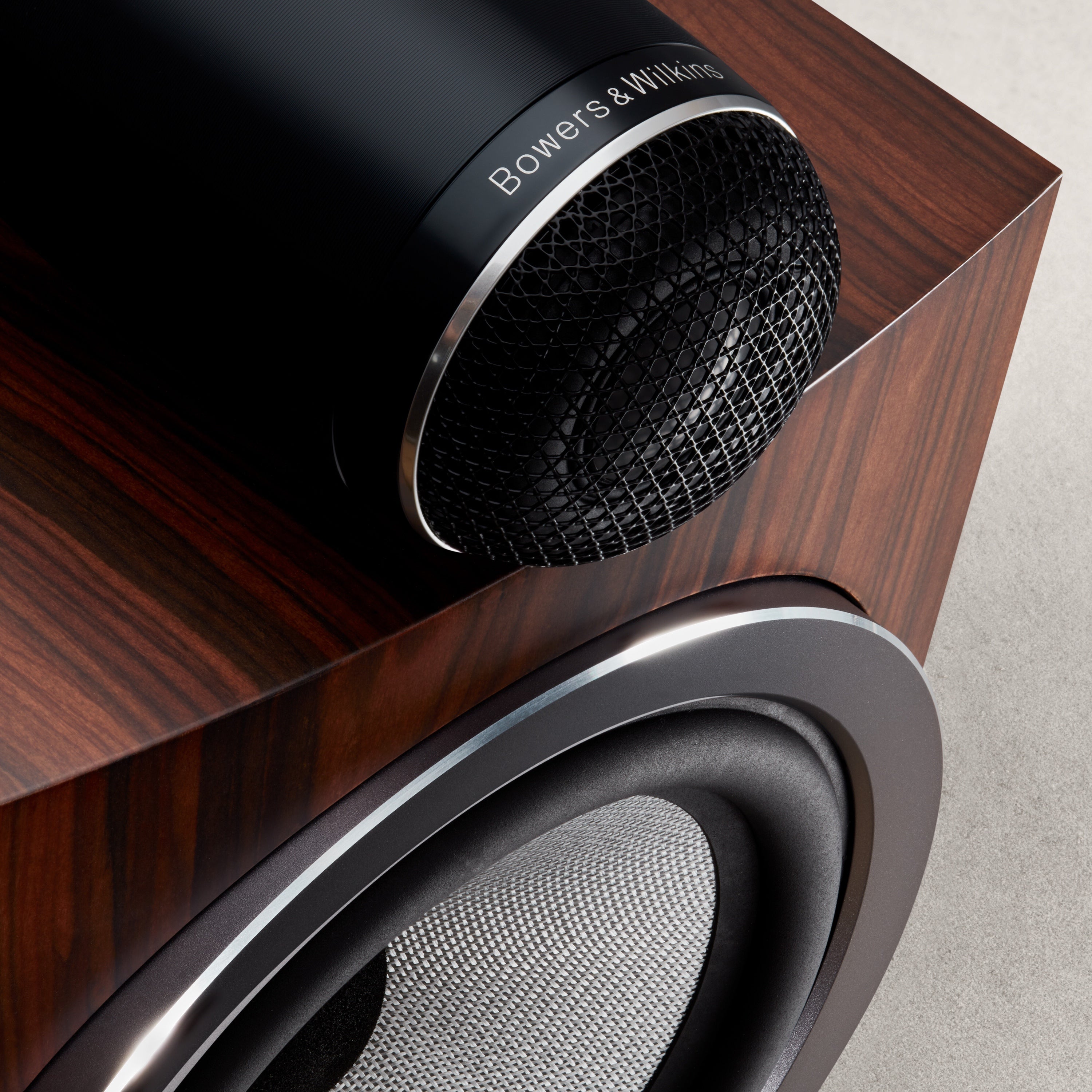 A closeup to solid body tweeter-on-top of a B&W 705 S3 Bookshelf Speaker in mocha color.