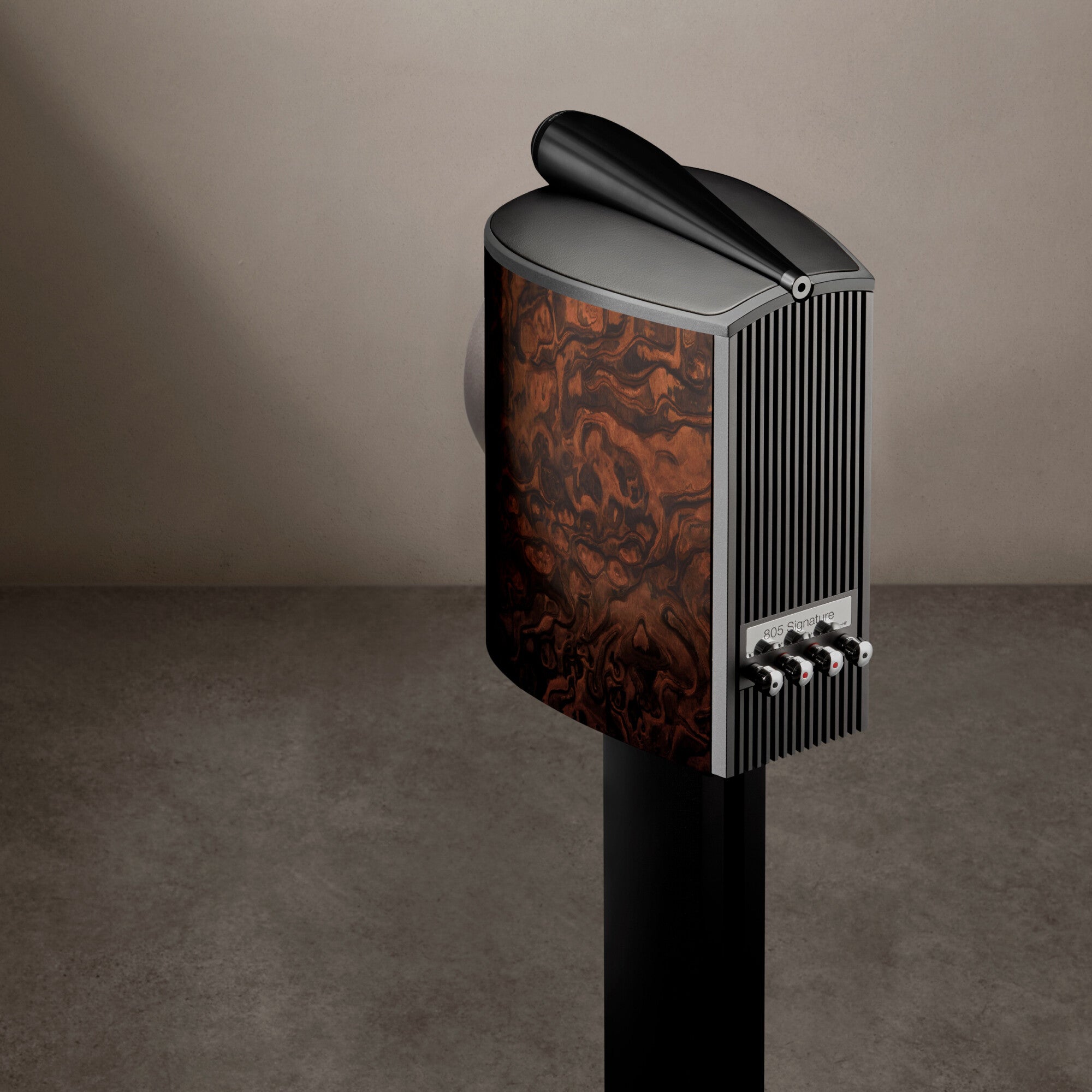 A back view of a B&W 805 Signature Bookshelf Speaker in California burl gloss finish.