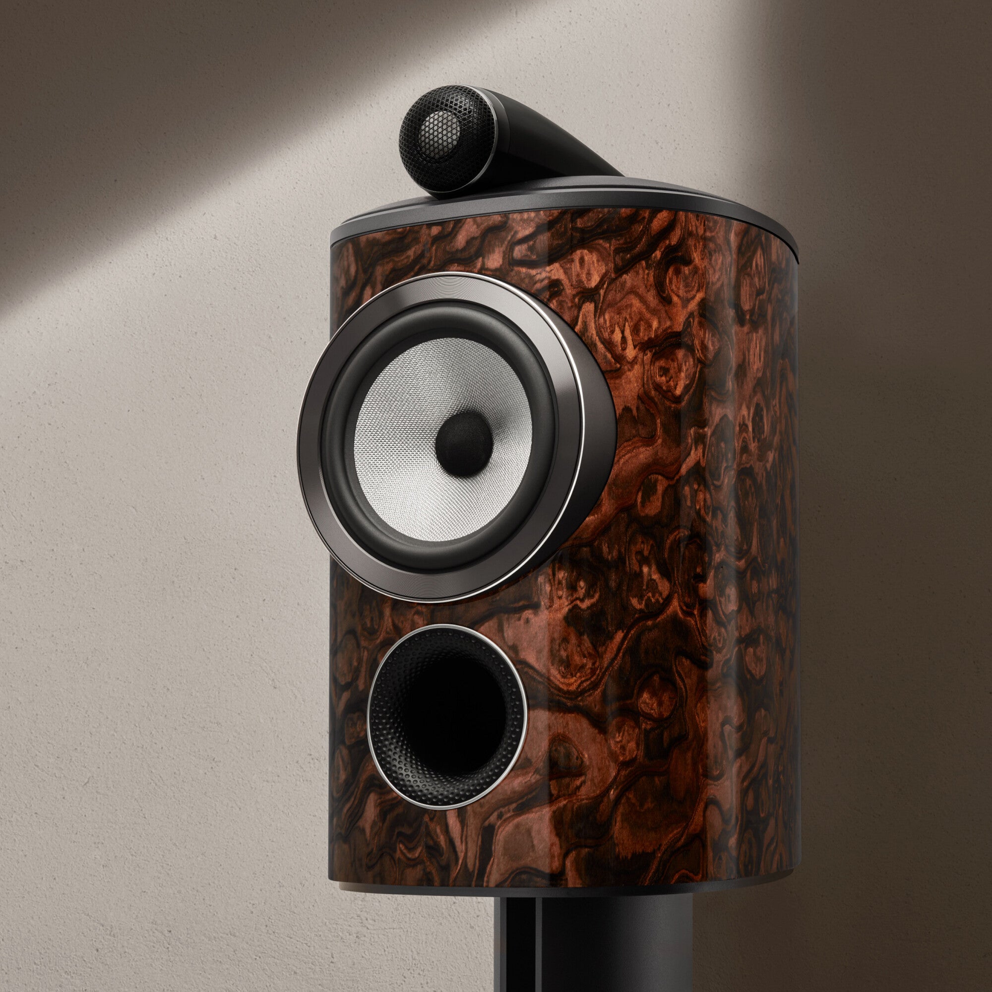 A front view of a B&W 805 Signature Bookshelf Speaker in California burl gloss finish.