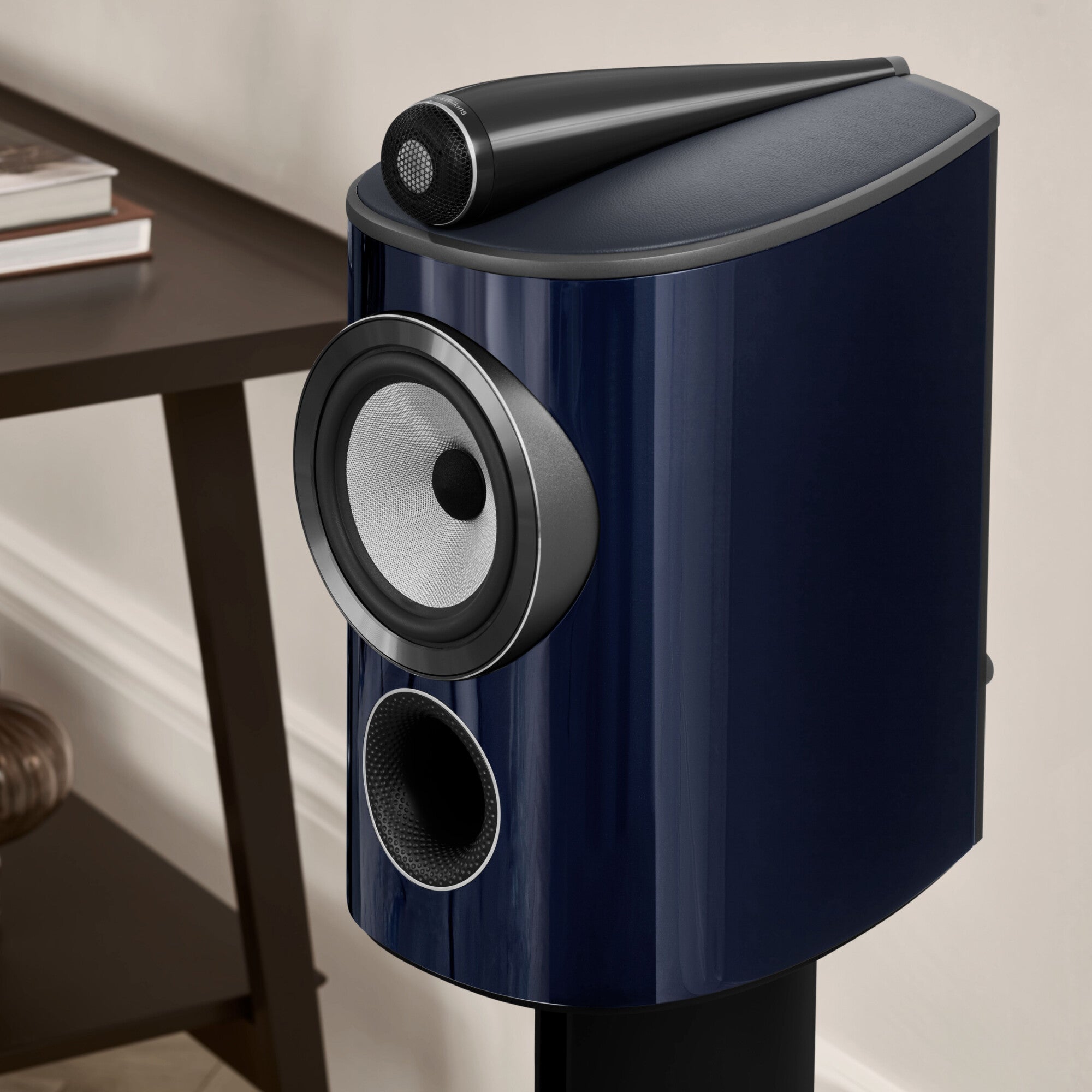 A closeup on a B&W 805 Signature Bookshelf Speaker in midnight blue metallic finish.