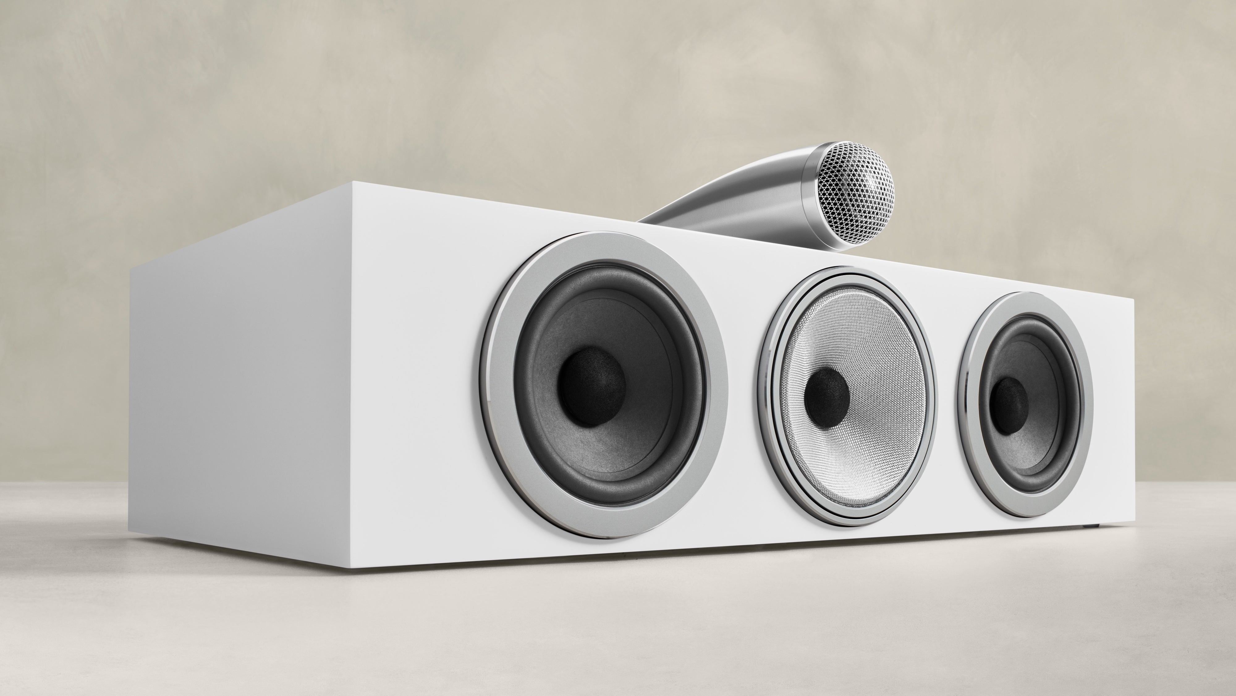 A B&W HTM71 S3 speaker in white finish on the ground.