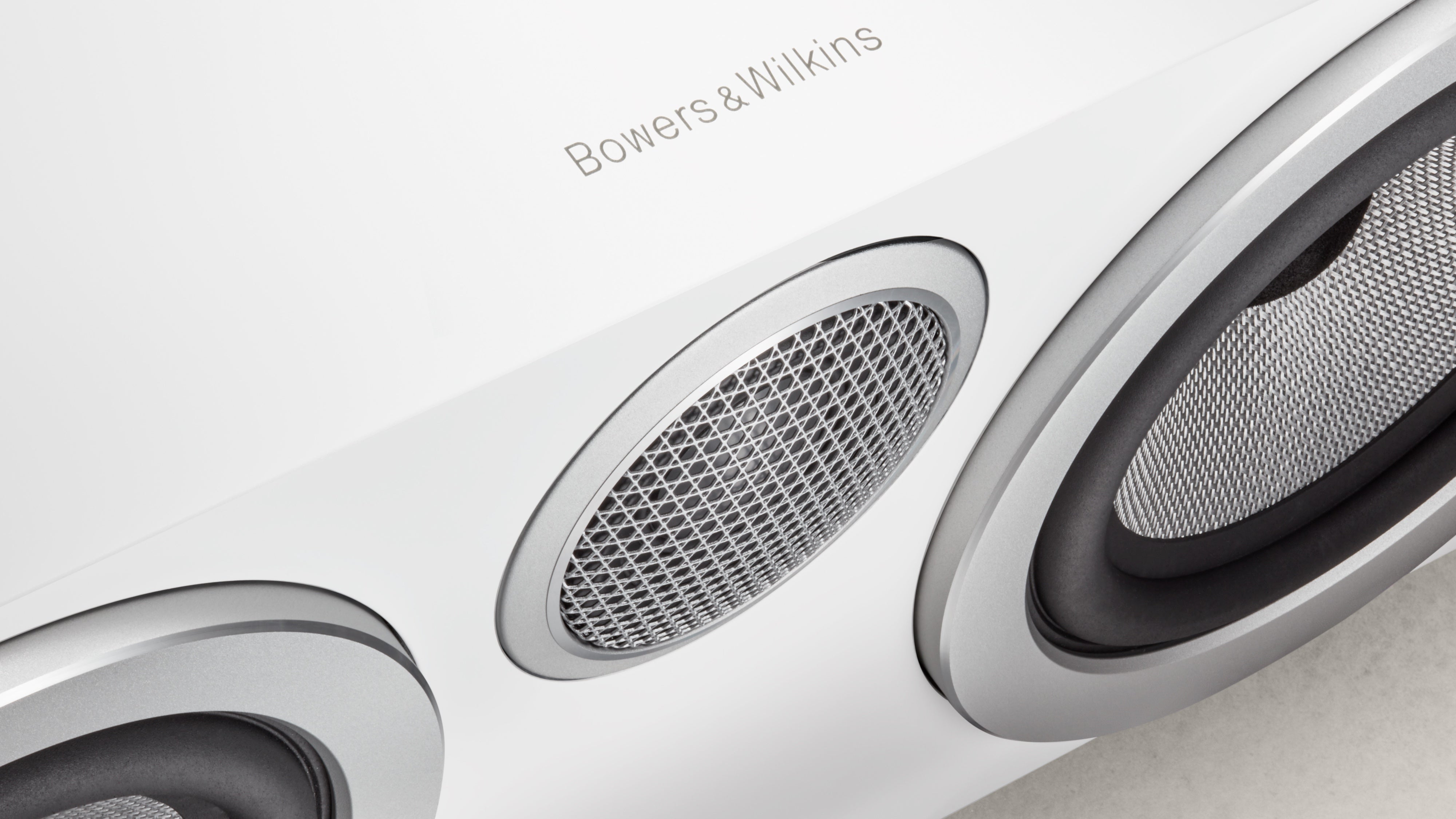 A closeup on a B&W logo on a HTM72 S3 Centre Channel speaker in satin white finish.