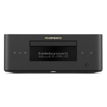 Marantz MCR 60n compact all-in-one hi-fi system – front view showing CD slot, OLED display playing Brandenburg Concerto, transport controls, and headphone jack